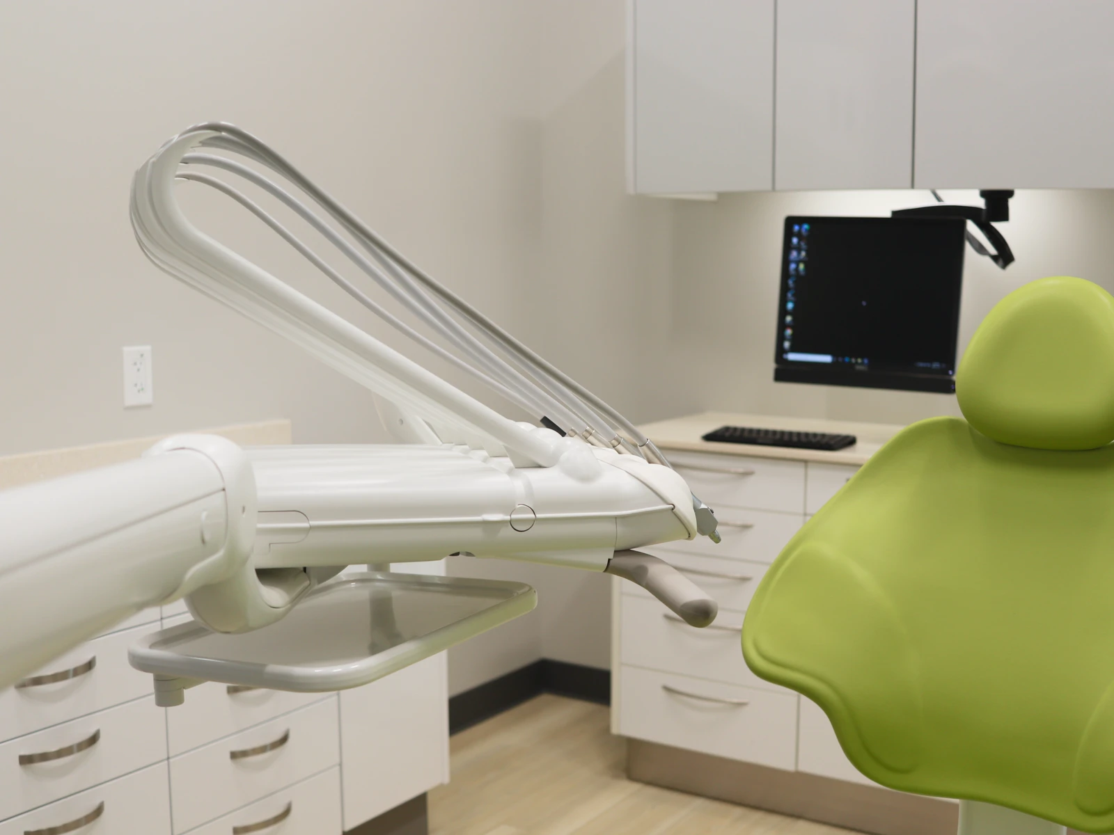 Treatment room with overhead monitor for patient entertainment during appointments