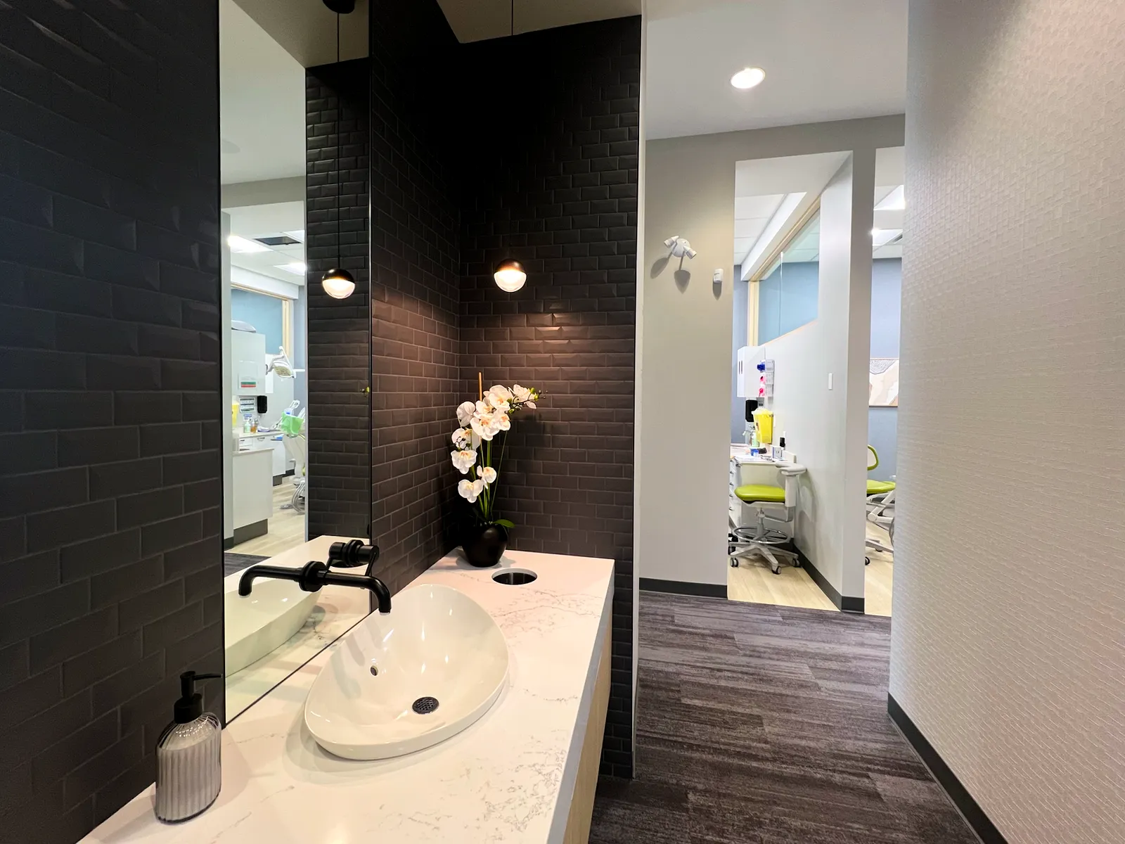 Hallway and patient rinse area with tiled backsplash